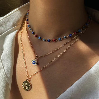 Dainty Layered Evil Eye Necklace Gold Plated stainless Steele with a Blue Eye Pendant and Multilayered and Adjustable Layering Choker Necklaces.